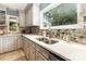 Well-lit kitchen with stainless steel sink, mosaic tile backsplash, and ample counter space at 3004 Vernell Ln, Shelby, NC 28150