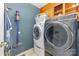 Functional laundry room with modern washer and dryer, storage cabinets, and convenient vacuum storage at 3004 Vernell Ln, Shelby, NC 28150