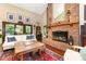 Cozy living room featuring a brick fireplace, hardwood floors, and abundant natural light at 3004 Vernell Ln, Shelby, NC 28150