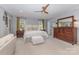 The open main bedroom features a ceiling fan, natural light from windows, and a private doorway at 3004 Vernell Ln, Shelby, NC 28150