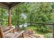 This screened-in porch has rocking chairs with a beautiful view of the landscaped backyard at 3004 Vernell Ln, Shelby, NC 28150