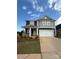 Two-story home boasts a symmetrical facade with a two-car garage and covered front porch at 309 Knotty Wood Dr # 78, Monroe, NC 28110
