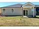 Backyard features a covered patio, sliding glass doors and a spacious grassy yard at 313 Knotty Wood Dr # 79, Monroe, NC 28110