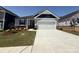 Charming single-story home featuring manicured landscaping and a spacious two-car garage in a desirable neighborhood at 313 Knotty Wood Dr # 79, Monroe, NC 28110