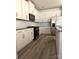 Modern kitchen with white cabinets, stainless steel appliances, hardwood floors and stylish backsplash at 313 Knotty Wood Dr # 79, Monroe, NC 28110
