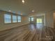 Spacious living room with ample natural light, complemented by sleek flooring, a sliding door, and recessed lighting at 313 Knotty Wood Dr # 79, Monroe, NC 28110