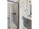 Modern bathroom with a glass shower, gray brick detail and black fixtures at 3626 S Tryon St # 21, Charlotte, NC 28217