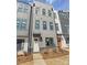 Newly built townhome featuring a modern facade with a white door and gray accents at 3626 S Tryon St # 21, Charlotte, NC 28217