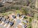 An aerial shot of houses in a cul-de-sac, with trees and a river in the background, surrounded by lush greenery at 8137 Bryson Rd, Fort Mill, SC 29707