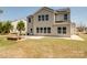 Backyard view of a two-story home with solar panels, a patio, and a well-maintained lawn at 8137 Bryson Rd, Fort Mill, SC 29707