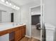 Bathroom with wooden vanity and mirror that flows into the bedroom at 8137 Bryson Rd, Fort Mill, SC 29707