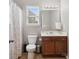 Cozy bathroom features wood cabinets, sink, toilet, shower, and window at 8137 Bryson Rd, Fort Mill, SC 29707