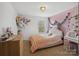 Charming bedroom with pink accent wall, creating a cozy and inviting atmosphere at 8137 Bryson Rd, Fort Mill, SC 29707