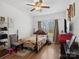Bedroom features a bed, wood floors, a ceiling fan, and natural light at 8137 Bryson Rd, Fort Mill, SC 29707