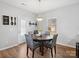 Dining room with a round wooden table, four upholstered chairs, and wood flooring at 8137 Bryson Rd, Fort Mill, SC 29707