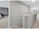 Bright hallway with neutral walls and carpet, leading to bedroom with gray walls at 8137 Bryson Rd, Fort Mill, SC 29707