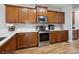 Bright kitchen features stainless steel appliances, wood cabinets, and tile backsplash at 8137 Bryson Rd, Fort Mill, SC 29707