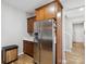 Kitchen with stainless steel refrigerator and wood cabinets near a staircase at 8137 Bryson Rd, Fort Mill, SC 29707