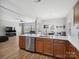 Open concept kitchen boasts stainless steel appliances, wood cabinets, and quartz countertops at 8137 Bryson Rd, Fort Mill, SC 29707
