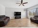 Spacious living room with hardwood floors, a large TV, and a cozy sofa, perfect for relaxing at 8137 Bryson Rd, Fort Mill, SC 29707