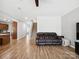 Bright living room with hardwood flooring, a sectional sofa, and staircase access to the upper level at 8137 Bryson Rd, Fort Mill, SC 29707