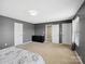 Serene main bedroom featuring neutral walls and carpet, complete with a large walk-in closet at 8137 Bryson Rd, Fort Mill, SC 29707