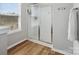 Modern bathroom shower enclosed with glass doors and updated fixtures for a sleek look at 8137 Bryson Rd, Fort Mill, SC 29707