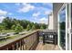 Balcony area with wood railings, outdoor grill, and view of the street and mature trees at 8232 Waxhaw Hwy, Waxhaw, NC 29173