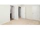 Neutral bedroom featuring three white doors with carpeted floor and white walls at 8232 Waxhaw Hwy, Waxhaw, NC 29173