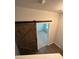 Bedroom entrance featuring sliding barn door leading to carpeted bedroom at 8232 Waxhaw Hwy, Waxhaw, NC 29173