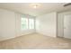Bright, empty bedroom featuring carpeted floor, white walls, and natural light at 8232 Waxhaw Hwy, Waxhaw, NC 29173