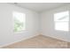 Cozy, naturally lit bedroom with neutral carpet, large windows offering a view, creating a peaceful retreat at 8232 Waxhaw Hwy, Waxhaw, NC 29173