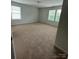 Spacious carpeted bedroom with natural light from double windows at 8232 Waxhaw Hwy, Waxhaw, NC 29173