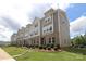 A row of modern townhouses with landscaped yards and well-maintained exteriors with brick and siding at 8232 Waxhaw Hwy, Waxhaw, NC 29173