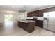 Open kitchen with island, stainless steel appliances, and seamless flow to outdoor balcony access at 8232 Waxhaw Hwy, Waxhaw, NC 29173