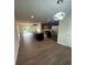 Open kitchen with dark cabinets, stainless steel appliances, island, and modern lighting fixtures at 8232 Waxhaw Hwy, Waxhaw, NC 29173