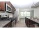 Well-appointed kitchen with stainless steel appliances, dark cabinetry, and granite countertops, merging style with functionality at 8232 Waxhaw Hwy, Waxhaw, NC 29173