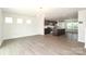 Open-concept living space with wood-look floors connecting the living room, kitchen and breakfast nook at 8232 Waxhaw Hwy, Waxhaw, NC 29173
