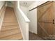 Carpeted staircase featuring a barn door on the right at 8232 Waxhaw Hwy, Waxhaw, NC 29173