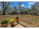 Inviting backyard deck with wooden railing and flowerpots with view to spacious yard at 1034 Marietta St, Charlotte, NC 28214