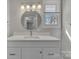 Bright bathroom with new vanity, modern fixtures, and a large round mirror at 1034 Marietta St, Charlotte, NC 28214