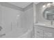 Bright bathroom with shower-tub combo, new vanity, and modern fixtures at 1034 Marietta St, Charlotte, NC 28214