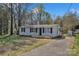 Charming one-story home with front porch, black shutters, and a driveway on a sunny day at 1034 Marietta St, Charlotte, NC 28214