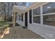Close up of the home's entry way and front porch, completed with fresh, natural-tone wood at 1034 Marietta St, Charlotte, NC 28214