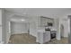 Modern kitchen with gray cabinets, stainless steel appliances, and an open view to the living room at 1034 Marietta St, Charlotte, NC 28214