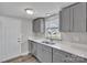 This well-lit kitchen has gray cabinets, stainless steel appliances, and new countertops at 1034 Marietta St, Charlotte, NC 28214