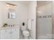 Classic bathroom with glass shower, white vanity, and a decorative, horizontal accent tile at 10602 Country Squire Ct, Matthews, NC 28105