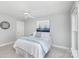 Bright bedroom features a ceiling fan, light-colored walls, and soft, neutral carpet at 10602 Country Squire Ct, Matthews, NC 28105