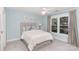 Comfortable bedroom with natural light, upholstered headboard, and neutral decor at 10602 Country Squire Ct, Matthews, NC 28105