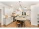 Elegant kitchen with center island, granite countertops, skylights, and custom cabinetry, offering a bright cooking experience at 10602 Country Squire Ct, Matthews, NC 28105